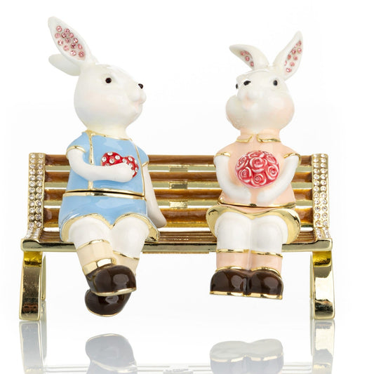 Keren Kopal 2 bunnies in love sitting on a bench, valentine flowers and chocolates