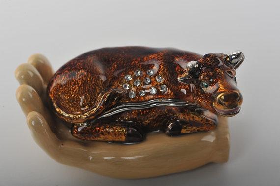 Keren Kopal Zodiac Ox Laying on Hand