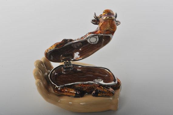 Keren Kopal Zodiac Ox Laying on Hand